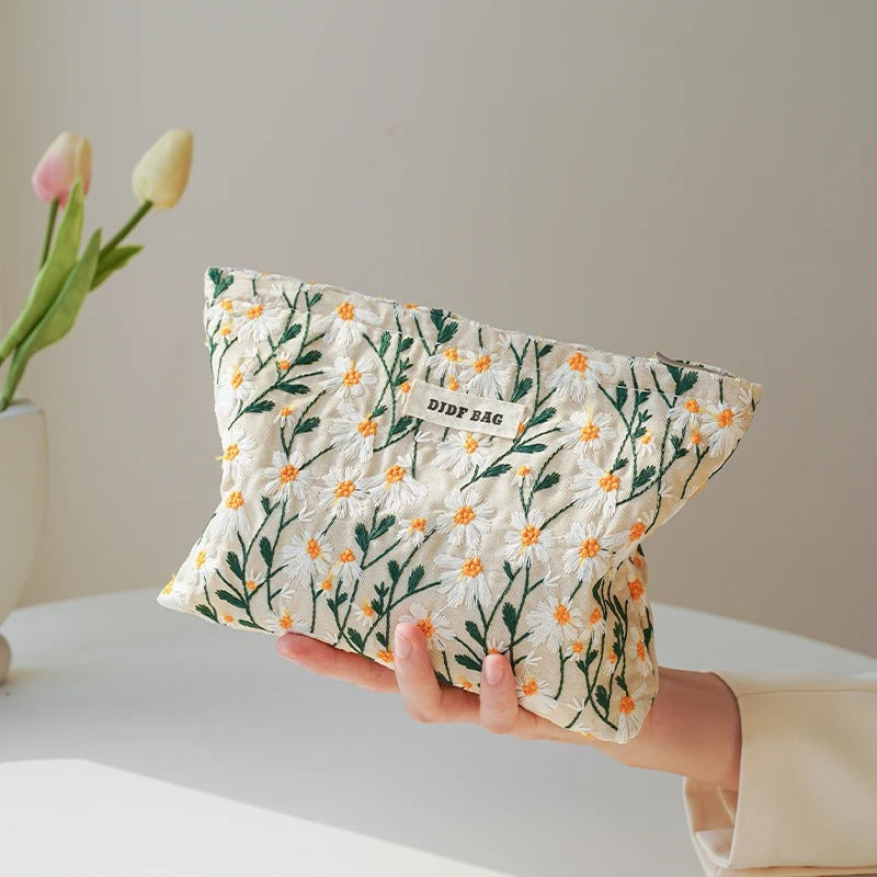 Blossom Bag by Lurixify – elegant floral cosmetic bag with gold accents.