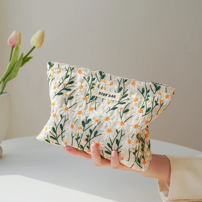 Blossom Bag by Lurixify – elegant floral cosmetic bag with gold accents.