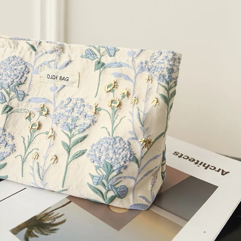 Close-up of Lurixify Blossom Bag showing refined floral fabric and gold detailing.